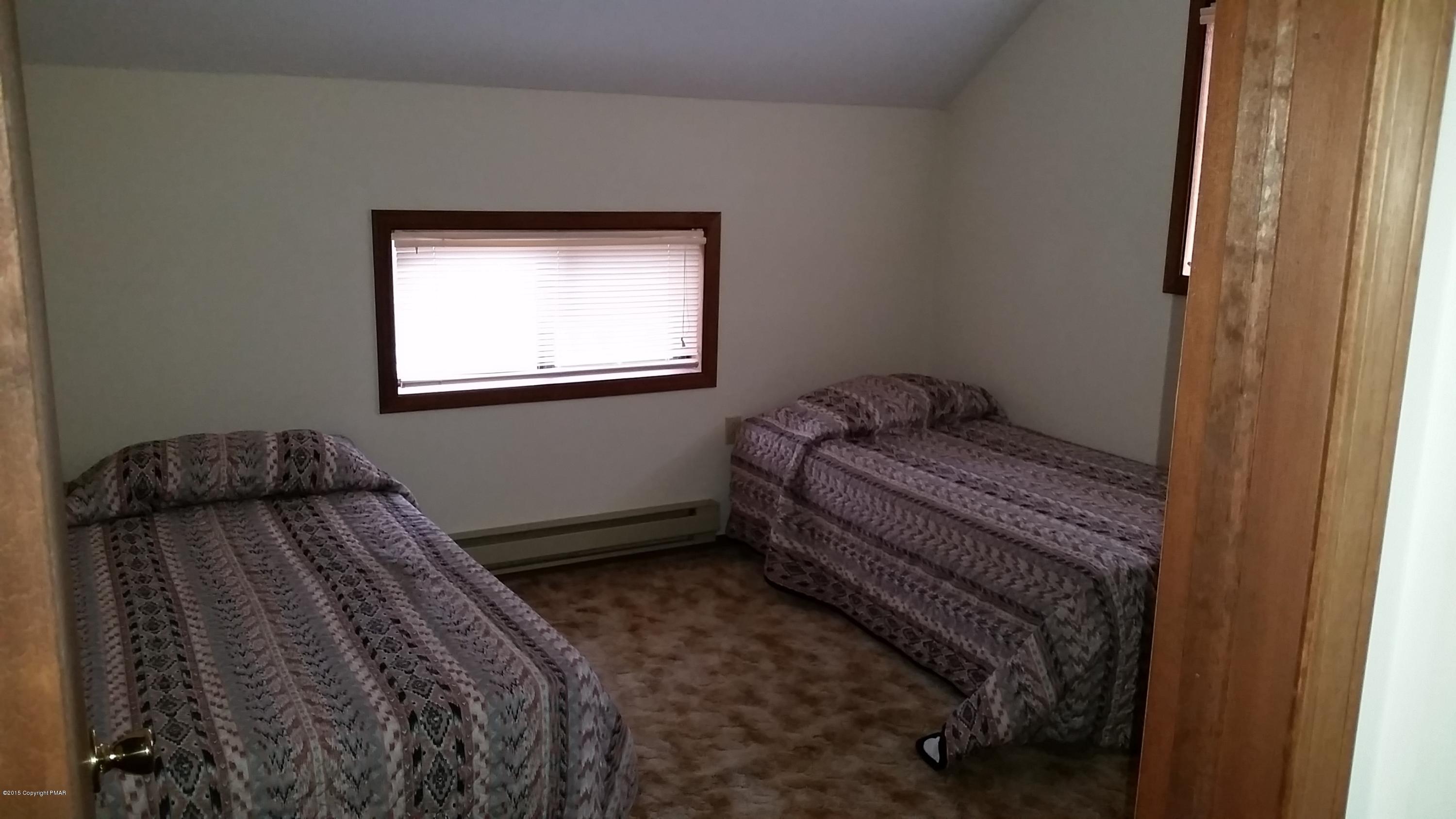 195 Gold Finch Road Bushkill, PA 18324 - Photo 6 of 14 a bedroom with a bed and a window