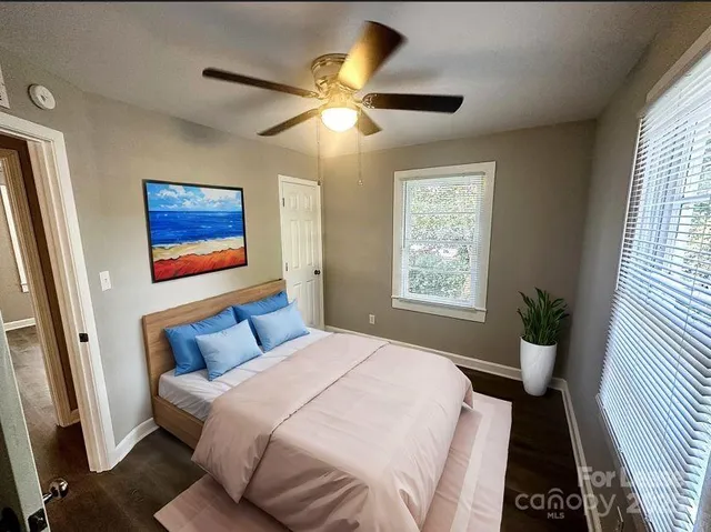 a bedroom with a bed and a large window