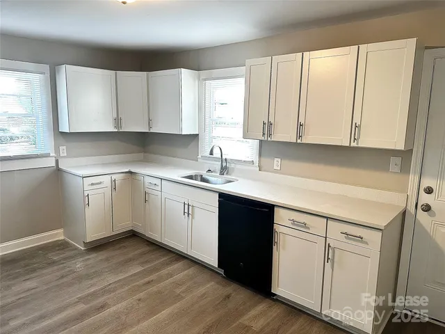 a kitchen with white cabinets sink and white appliances