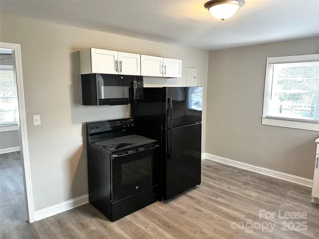 a kitchen with a refrigerator stove and microwave