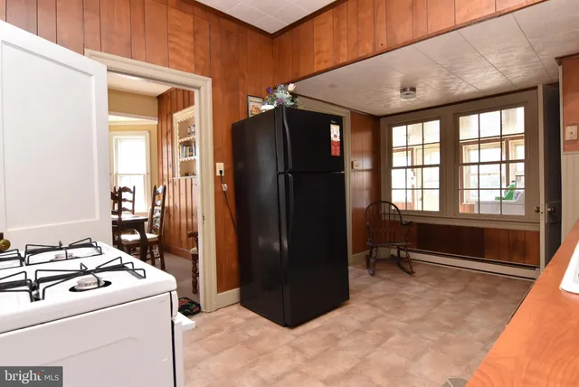 a kitchen with a refrigerator and a stove