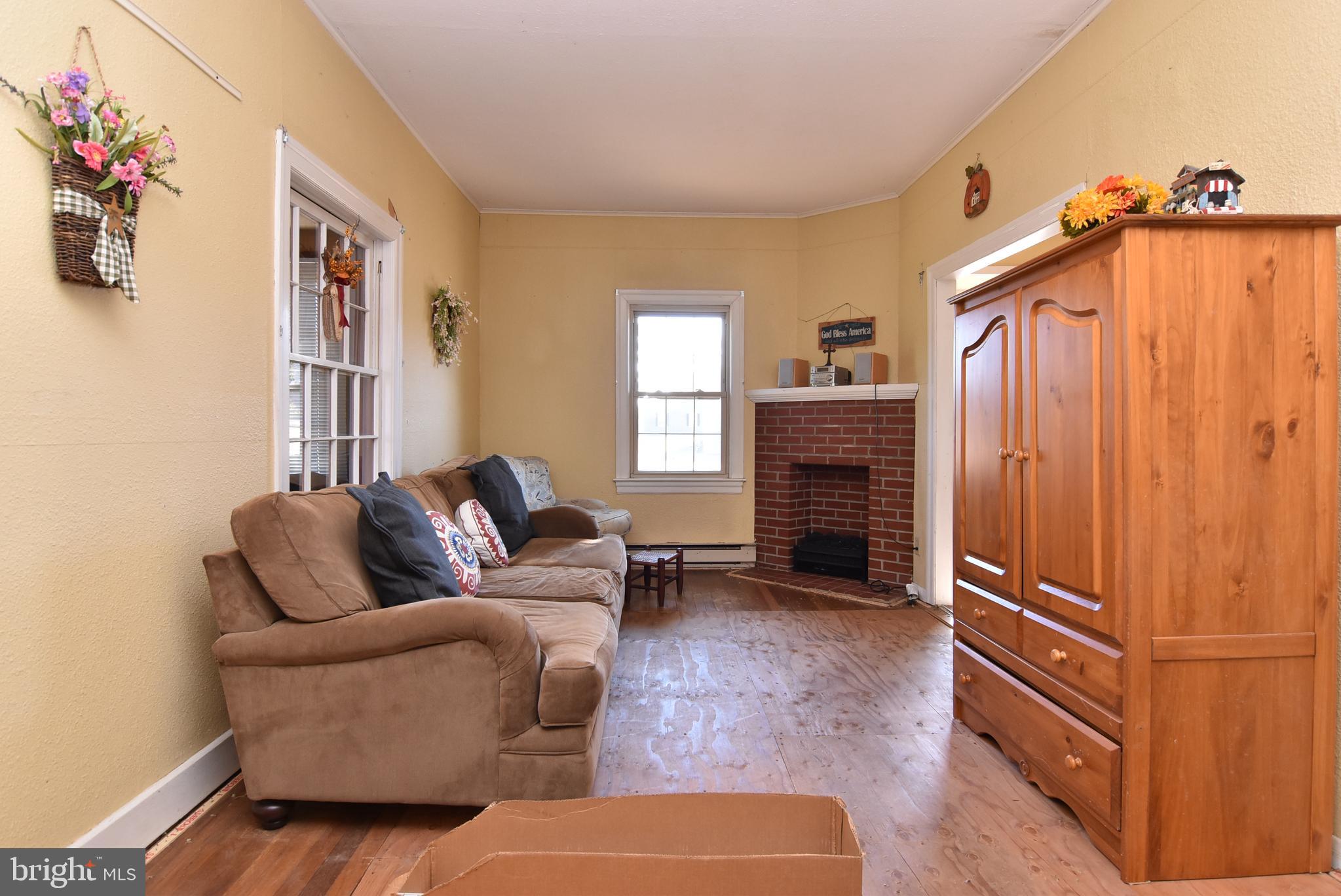 28740 Seaford Road Laurel, DE 19956 - Photo 35 of 44 a living room with furniture a flat screen tv and a fireplace