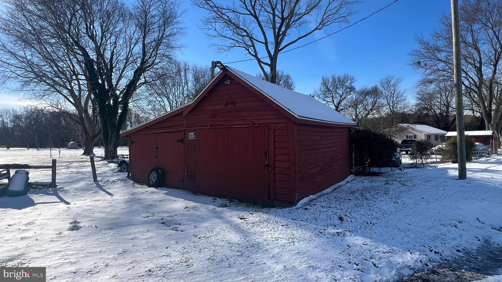 28740 Seaford Road Laurel, DE 19956 - Photo 8 of 44 a view of a house with a yard covered with snow in the forest