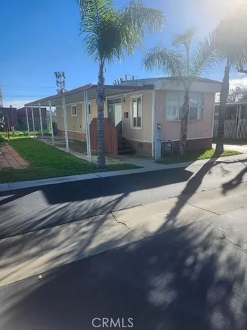 a view of a white house with a yard