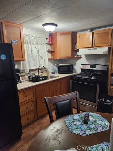 a kitchen with a stove a sink and cabinets