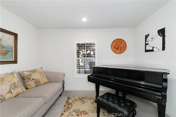a living room with a couch and a wall painting