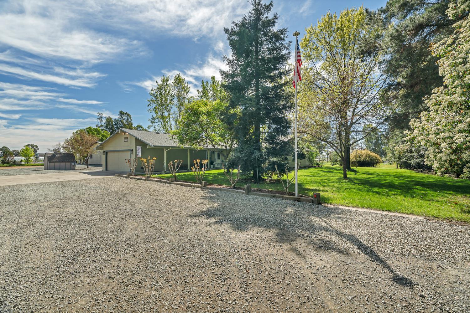 12354 Hobday Road Wilton, CA 95693 - Photo 12 of 77 view of front of house featuring concrete driveway, a front yard, and an attached garage
