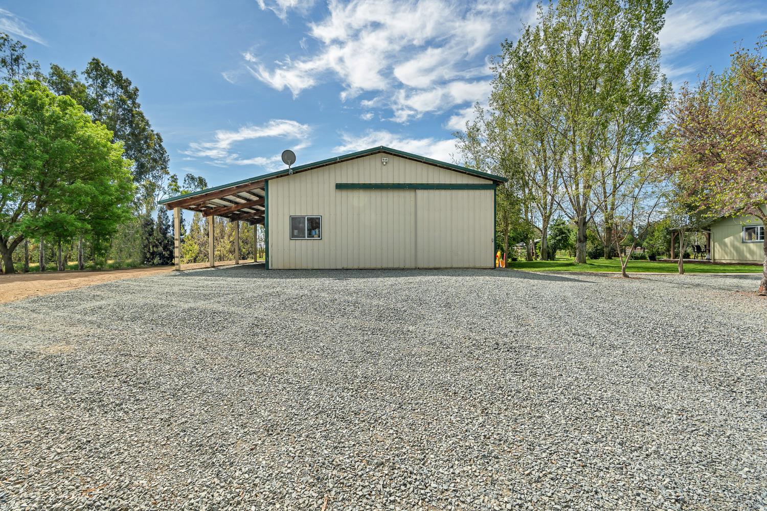 12354 Hobday Road Wilton, CA 95693 - Photo 31 of 77 view of property exterior featuring an outdoor structure, a pole building, and driveway