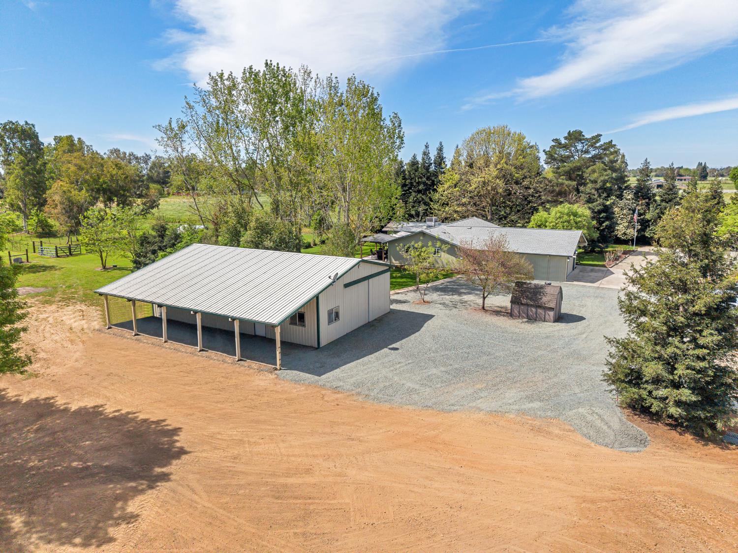 12354 Hobday Road Wilton, CA 95693 - Photo 35 of 77 view of subject property featuring a tree filled landscape