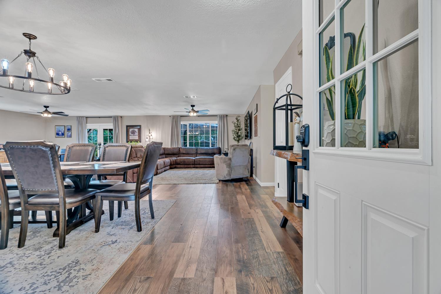 12354 Hobday Road Wilton, CA 95693 - Photo 38 of 77 dining space with ceiling fan, dark wood-style flooring, and a chandelier