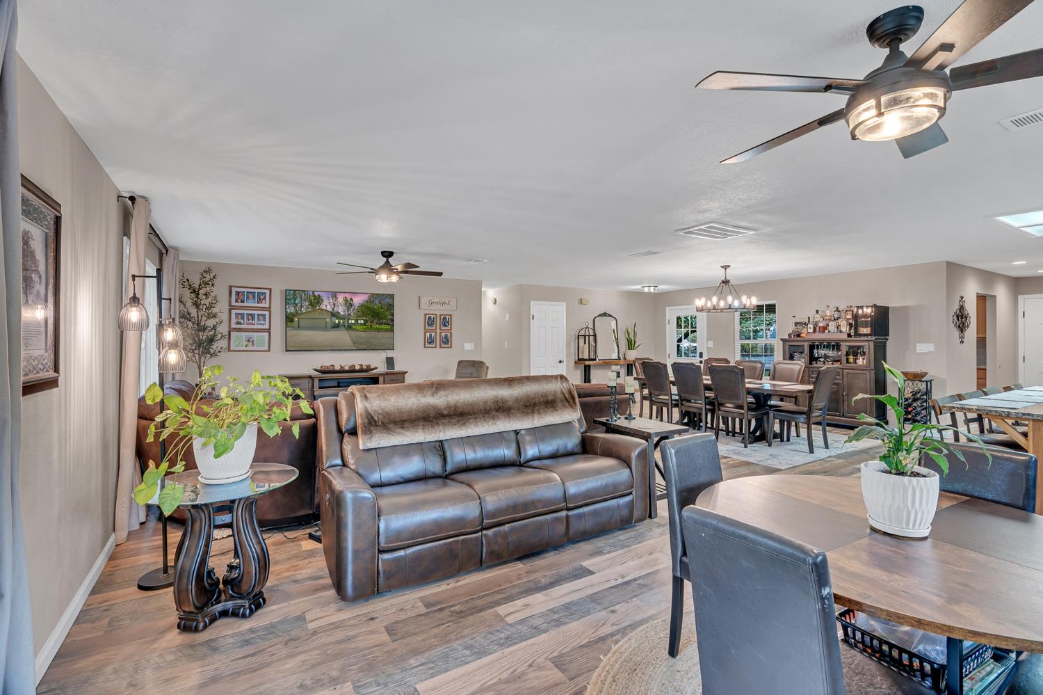 12354 Hobday Road Wilton, CA 95693 - Photo 44 of 77 living area with a ceiling fan, wood finished floors, and suspended lighting