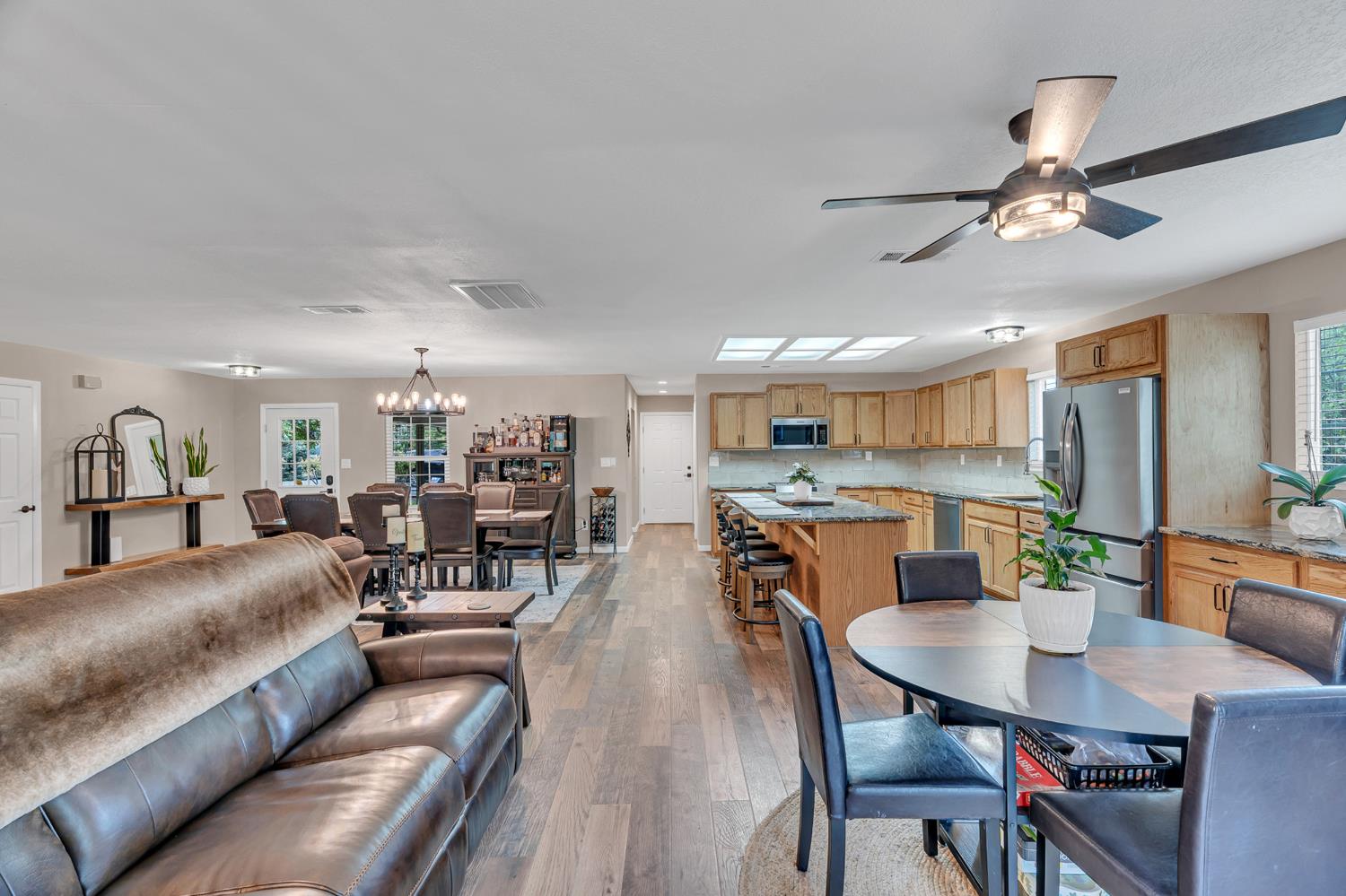 12354 Hobday Road Wilton, CA 95693 - Photo 45 of 77 dining area with light wood-type flooring, a ceiling fan, and suspended lighting