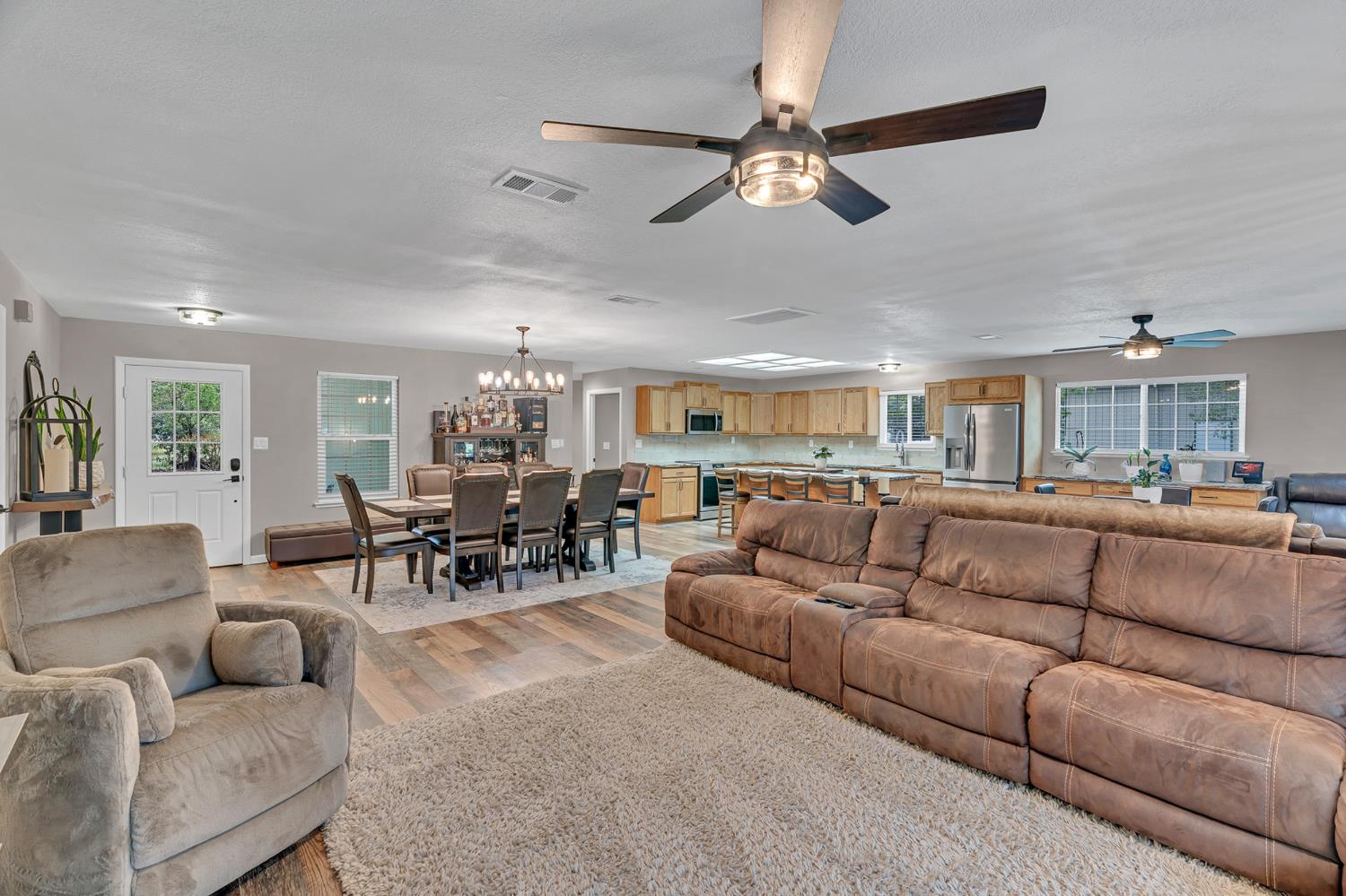 12354 Hobday Road Wilton, CA 95693 - Photo 46 of 77 living area featuring light wood-style floors, plenty of natural light, hanging lights, and a ceiling fan
