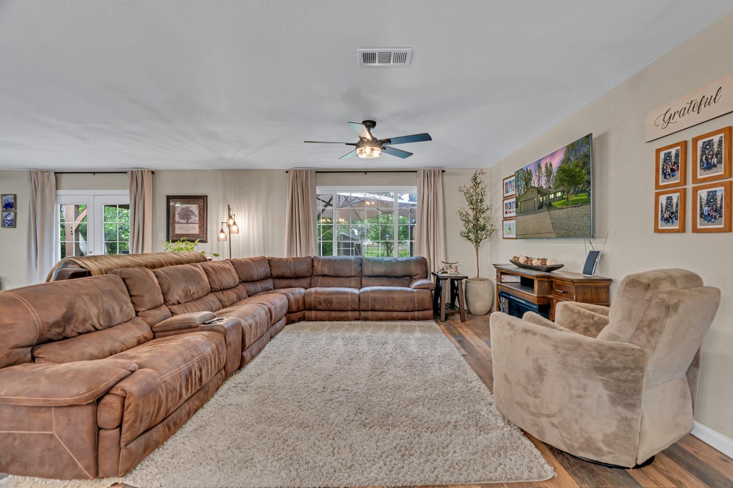 12354 Hobday Road Wilton, CA 95693 - Photo 48 of 77 living room featuring wood finished floors, a ceiling fan, plenty of natural light, and french doors
