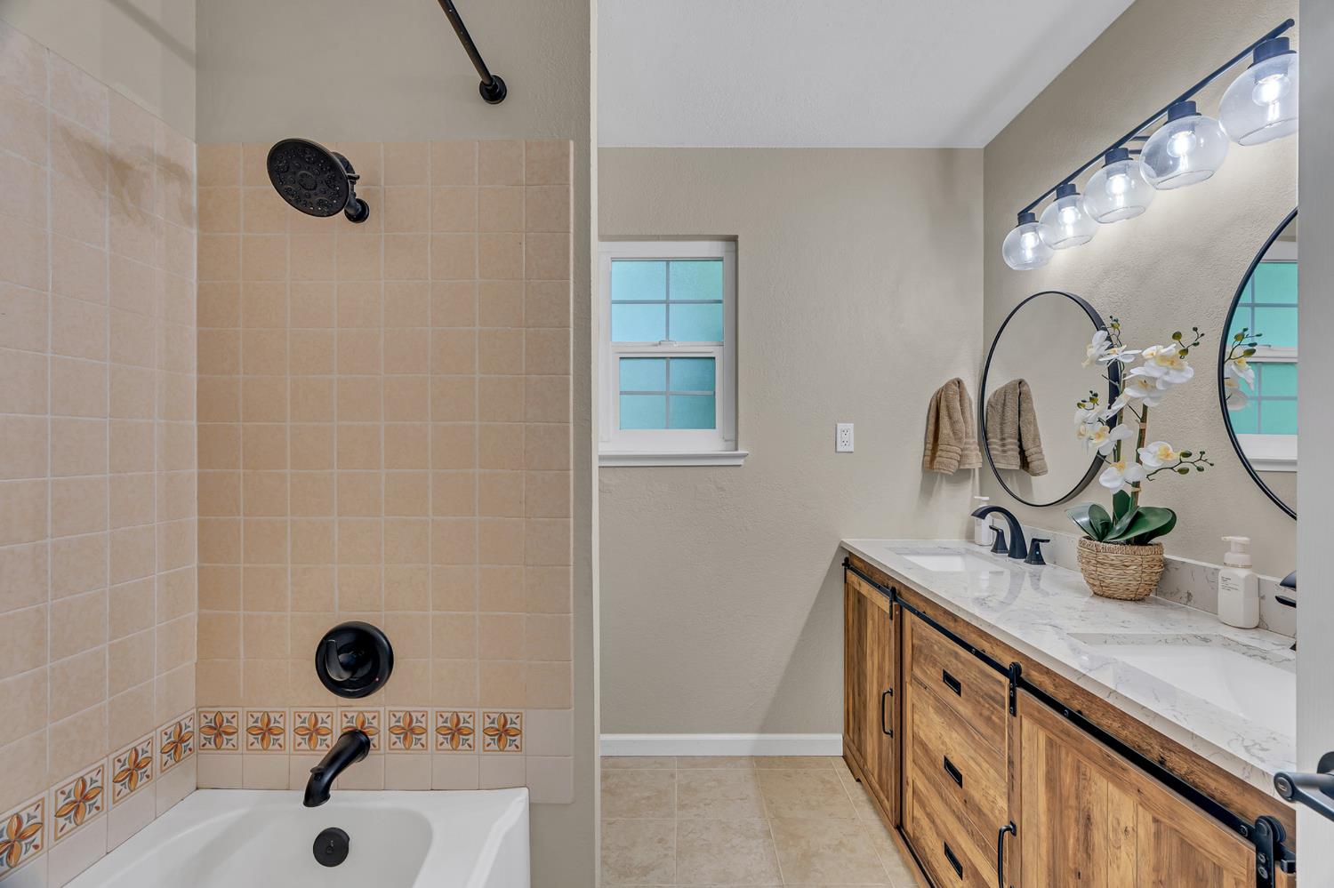 12354 Hobday Road Wilton, CA 95693 - Photo 54 of 77 bathroom featuring double vanity, shower / washtub combination, and light tile patterned floors