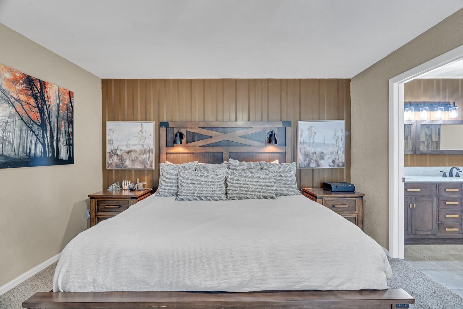 12354 Hobday Road Wilton, CA 95693 - Photo 57 of 77 bedroom with ensuite bathroom, light colored carpet, and wood walls