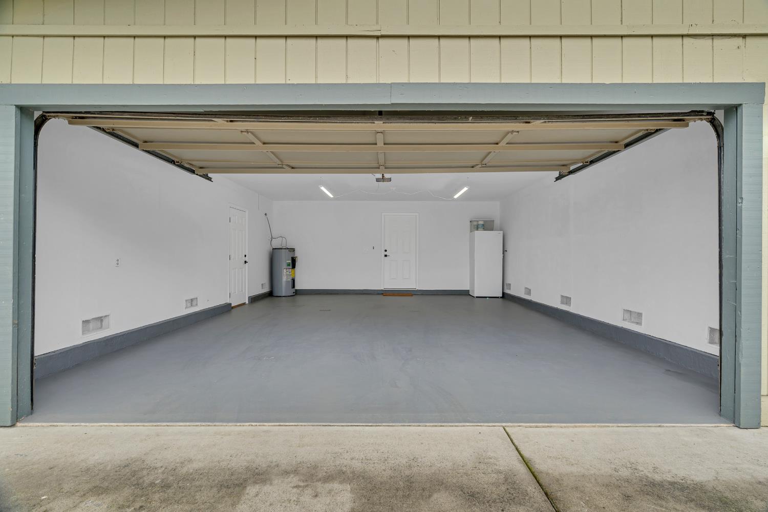 12354 Hobday Road Wilton, CA 95693 - Photo 64 of 77 garage featuring white refrigerator and water heater