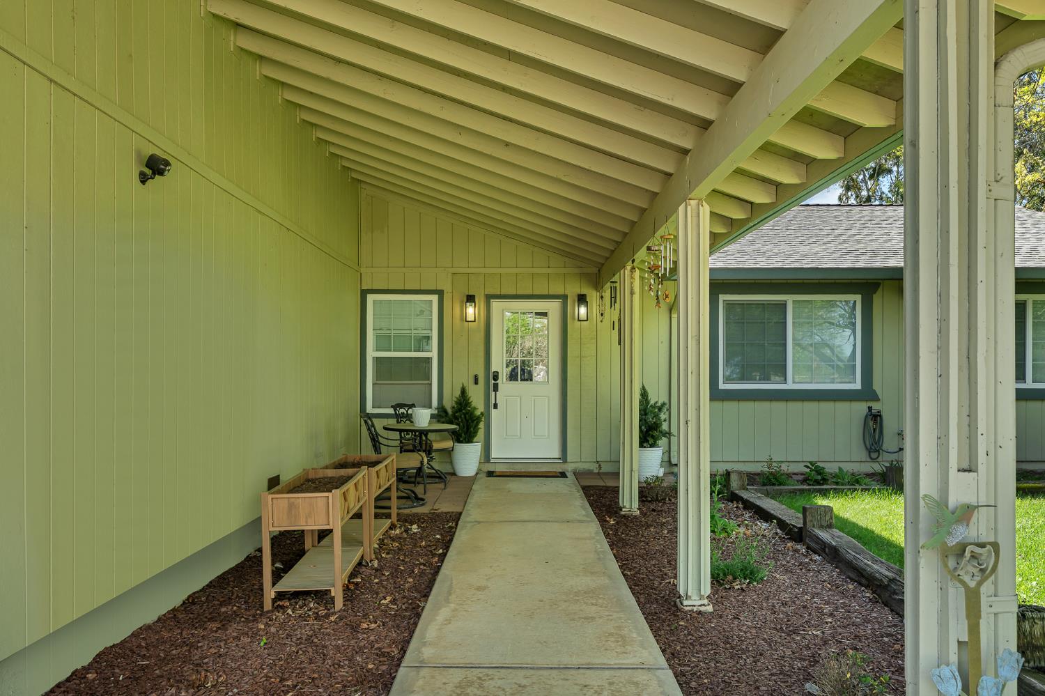 12354 Hobday Road Wilton, CA 95693 - Photo 7 of 77 doorway to property featuring roof with shingles and covered porch
