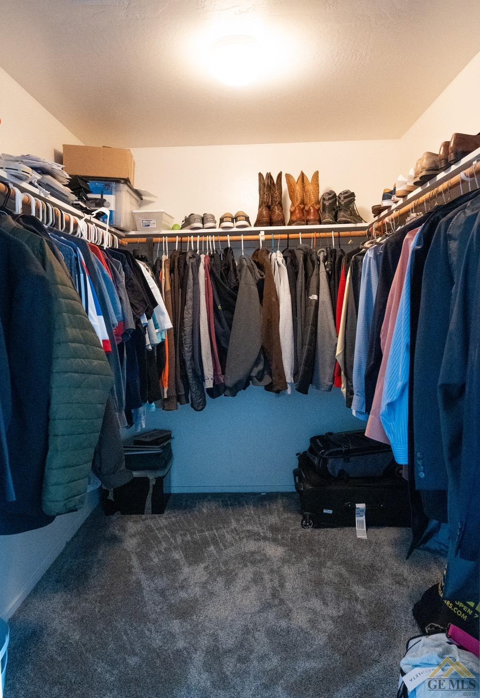 Undisclosed Address Bakersfield, CA 93312 - Photo 12 of 21 a view of walk in closet with clothes and shoes