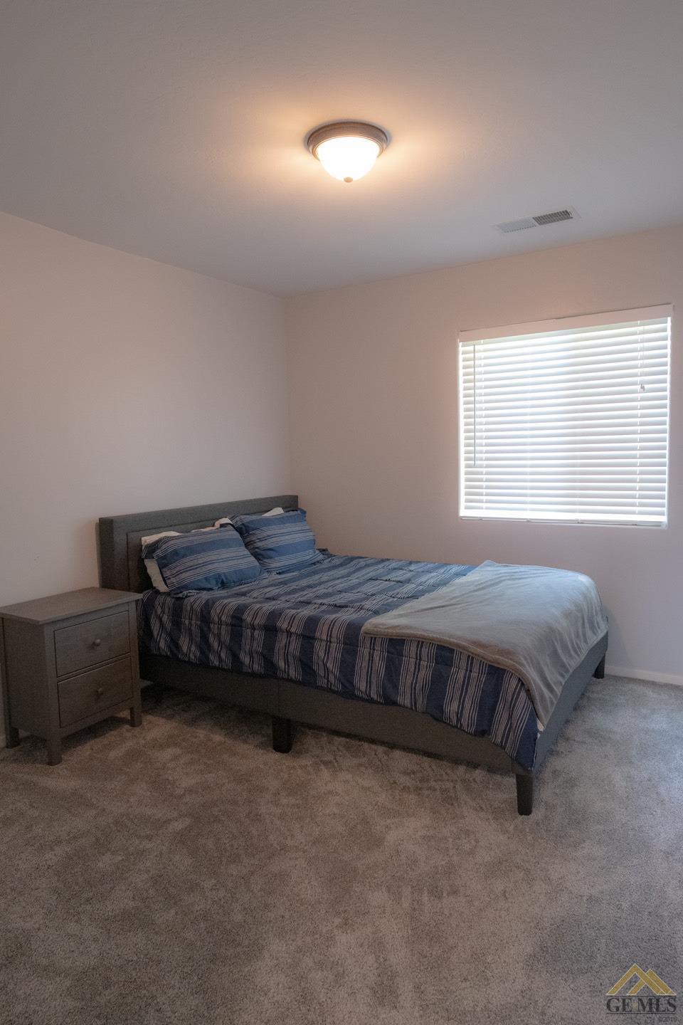 Undisclosed Address Bakersfield, CA 93312 - Photo 15 of 21 a bedroom with a bed and window