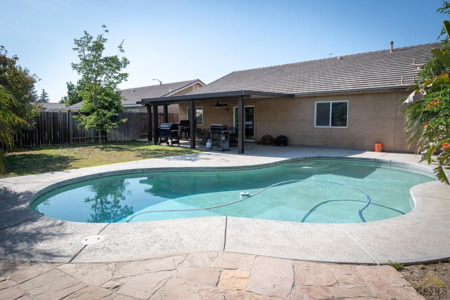 Undisclosed Address Bakersfield, CA 93312 - Photo 18 of 21 a view of a house with a swimming pool
