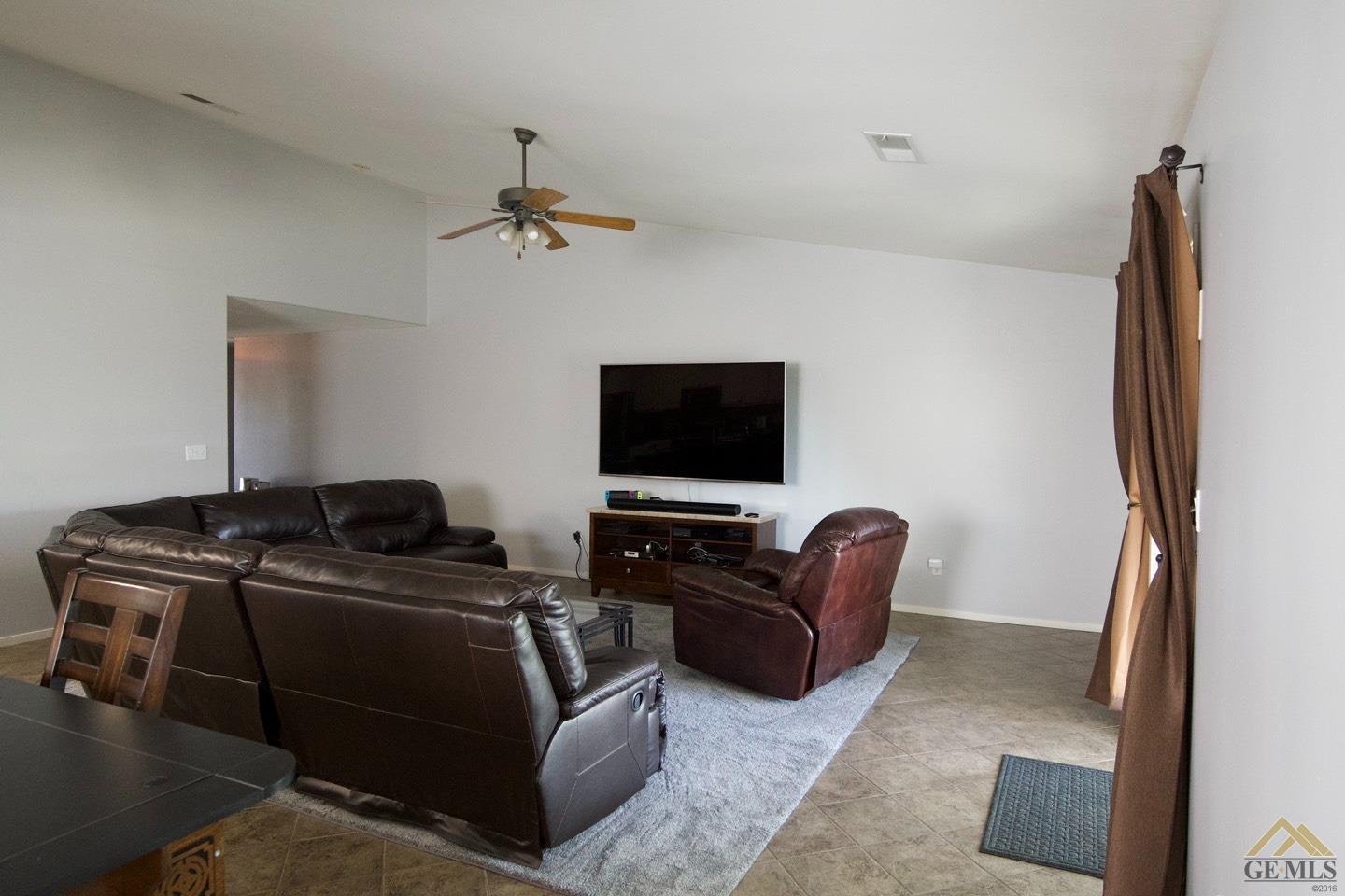 Undisclosed Address Bakersfield, CA 93312 - Photo 3 of 21 a living room with furniture and a flat screen tv
