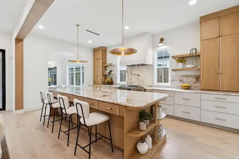 a kitchen with a table chairs refrigerator and cabinets