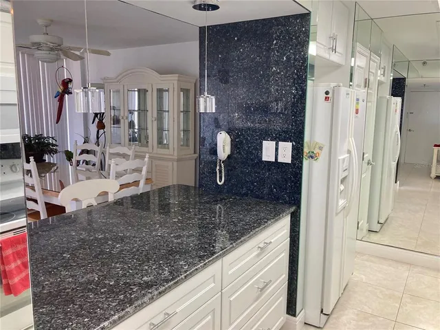 a kitchen with granite countertop a sink and cabinets
