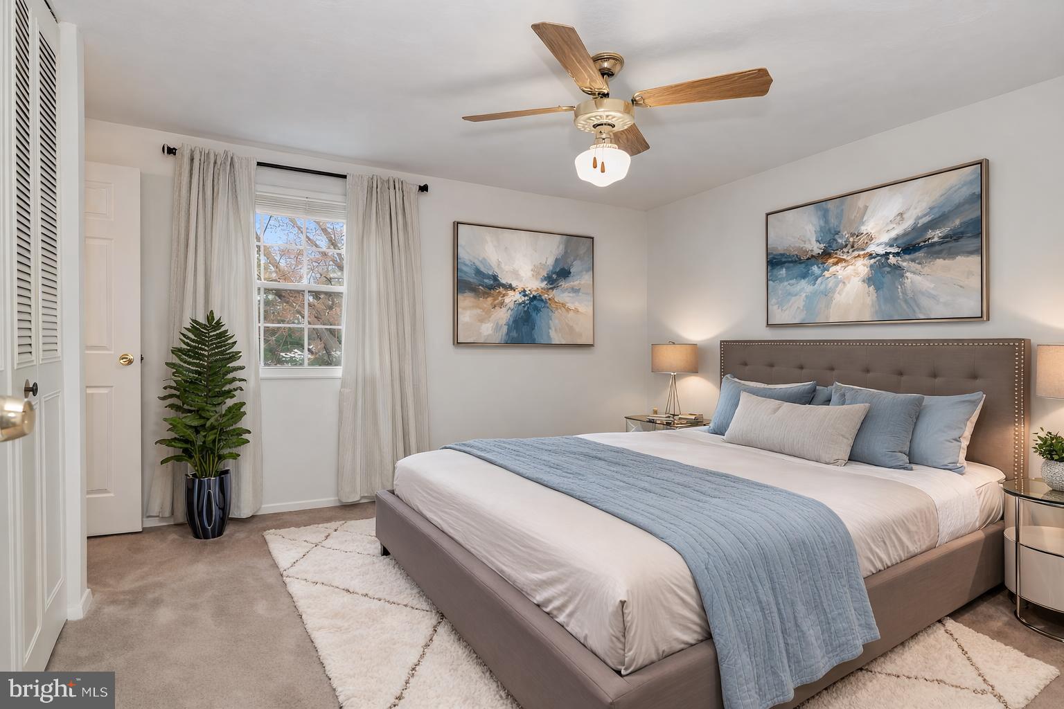 2806 Logway Road Vienna, VA 22181 - Photo 12 of 42 a bedroom with a large bed and a chandelier