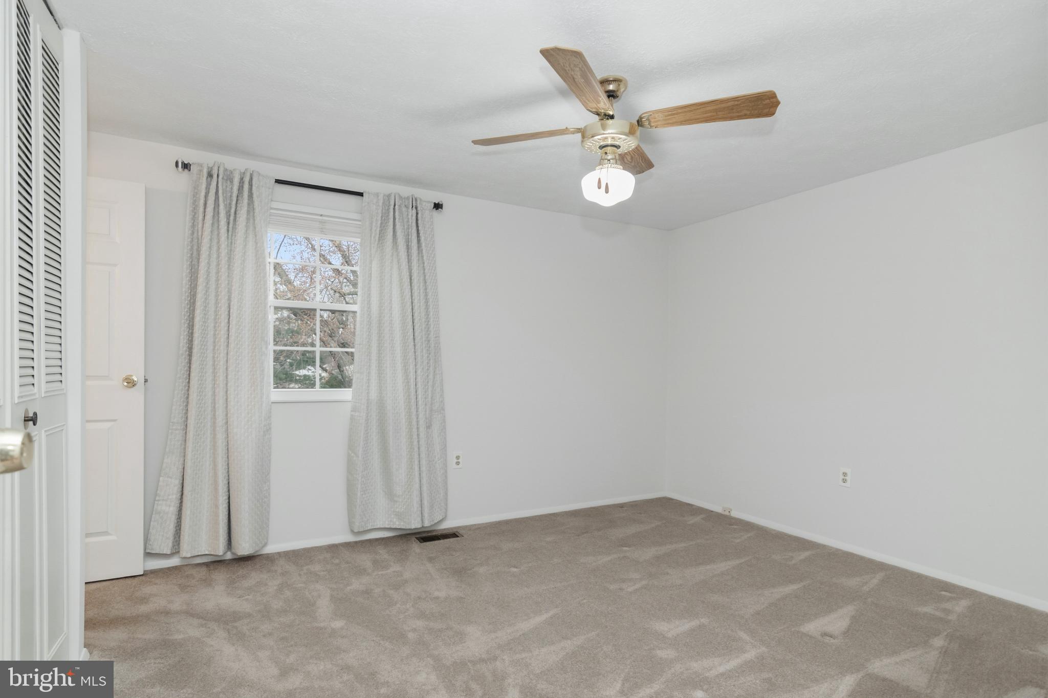 2806 Logway Road Vienna, VA 22181 - Photo 13 of 42 an empty room with a window and a fan