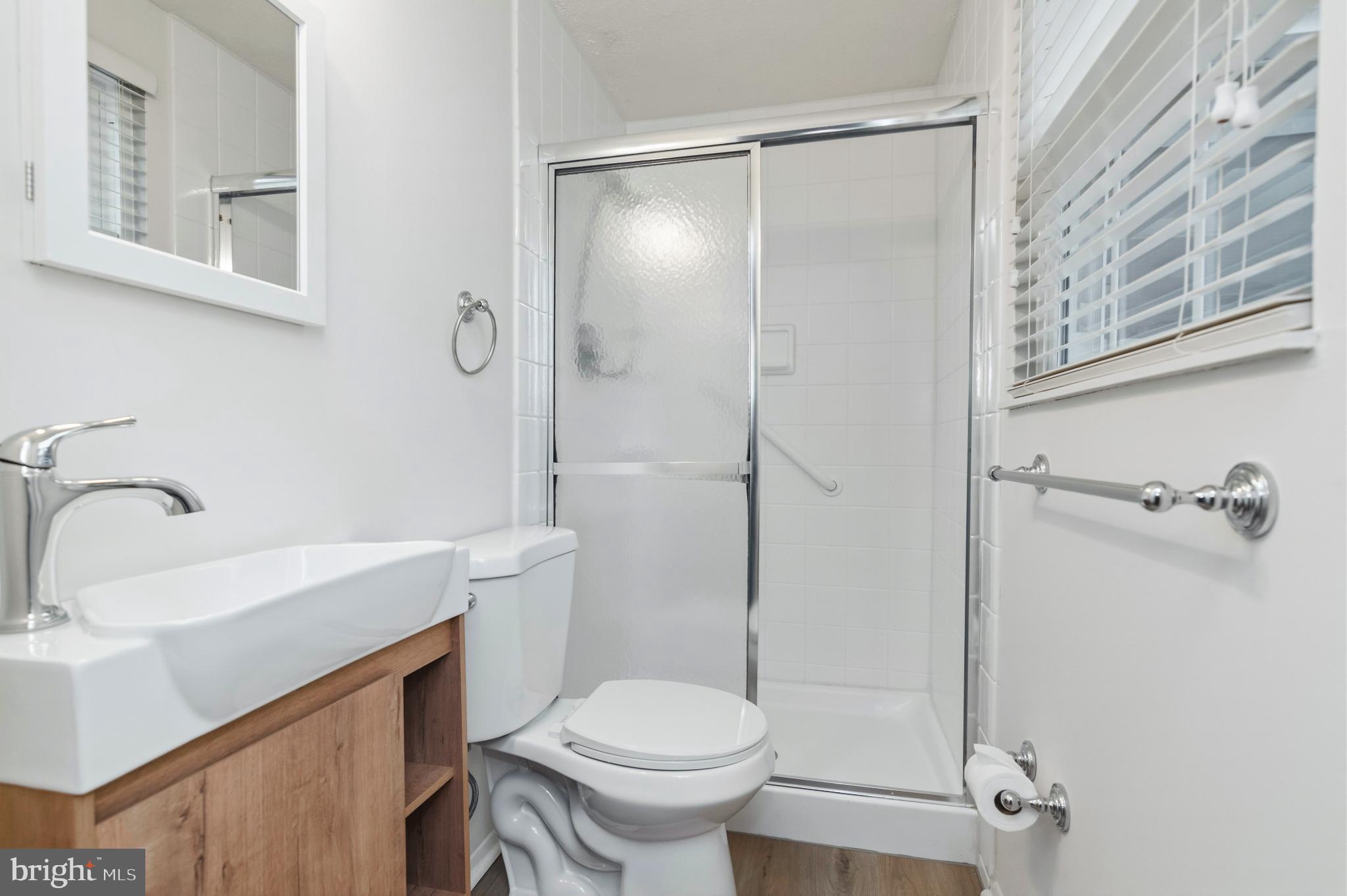2806 Logway Road Vienna, VA 22181 - Photo 15 of 42 a bathroom with a sink toilet and shower