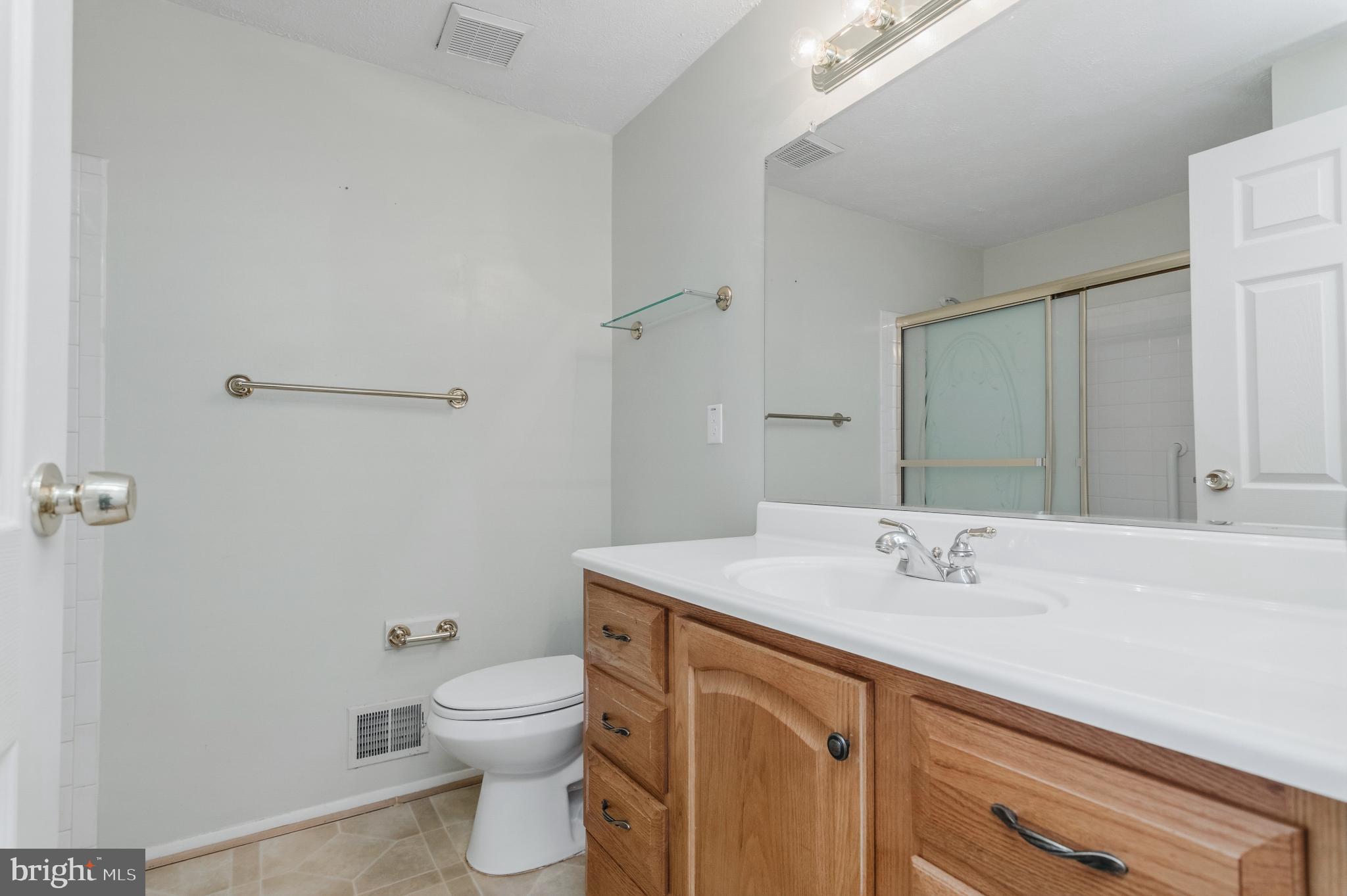 2806 Logway Road Vienna, VA 22181 - Photo 19 of 42 a bathroom with a sink a toilet and mirror