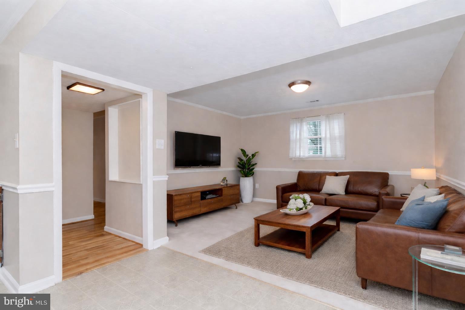 2806 Logway Road Vienna, VA 22181 - Photo 25 of 42 a living room with furniture and a flat screen tv