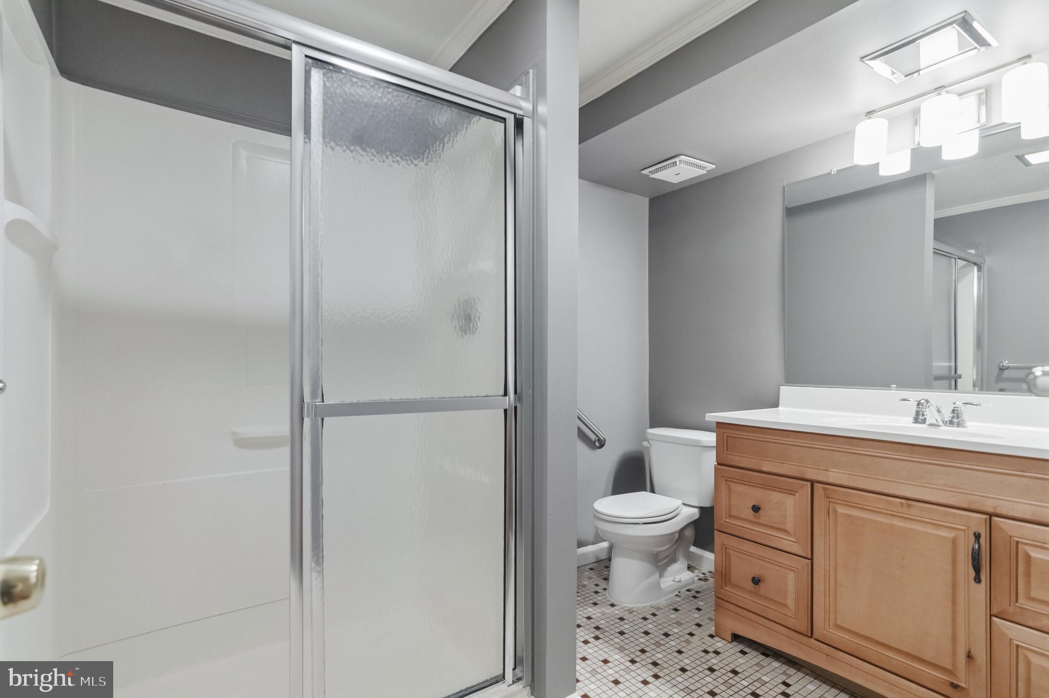 2806 Logway Road Vienna, VA 22181 - Photo 29 of 42 a bathroom with a granite countertop sink toilet and shower