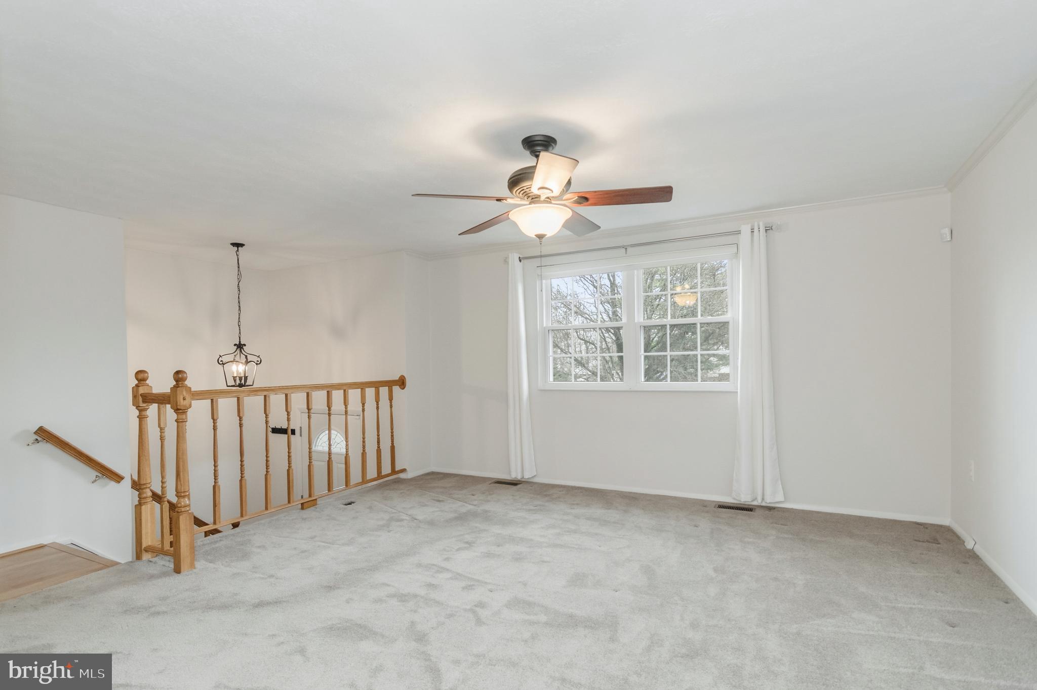 2806 Logway Road Vienna, VA 22181 - Photo 3 of 42 a view of a livingroom with wooden floor a ceiling fan and windows