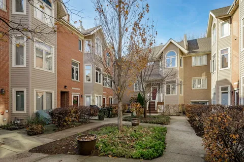 a front view of a residential apartment building with a yard