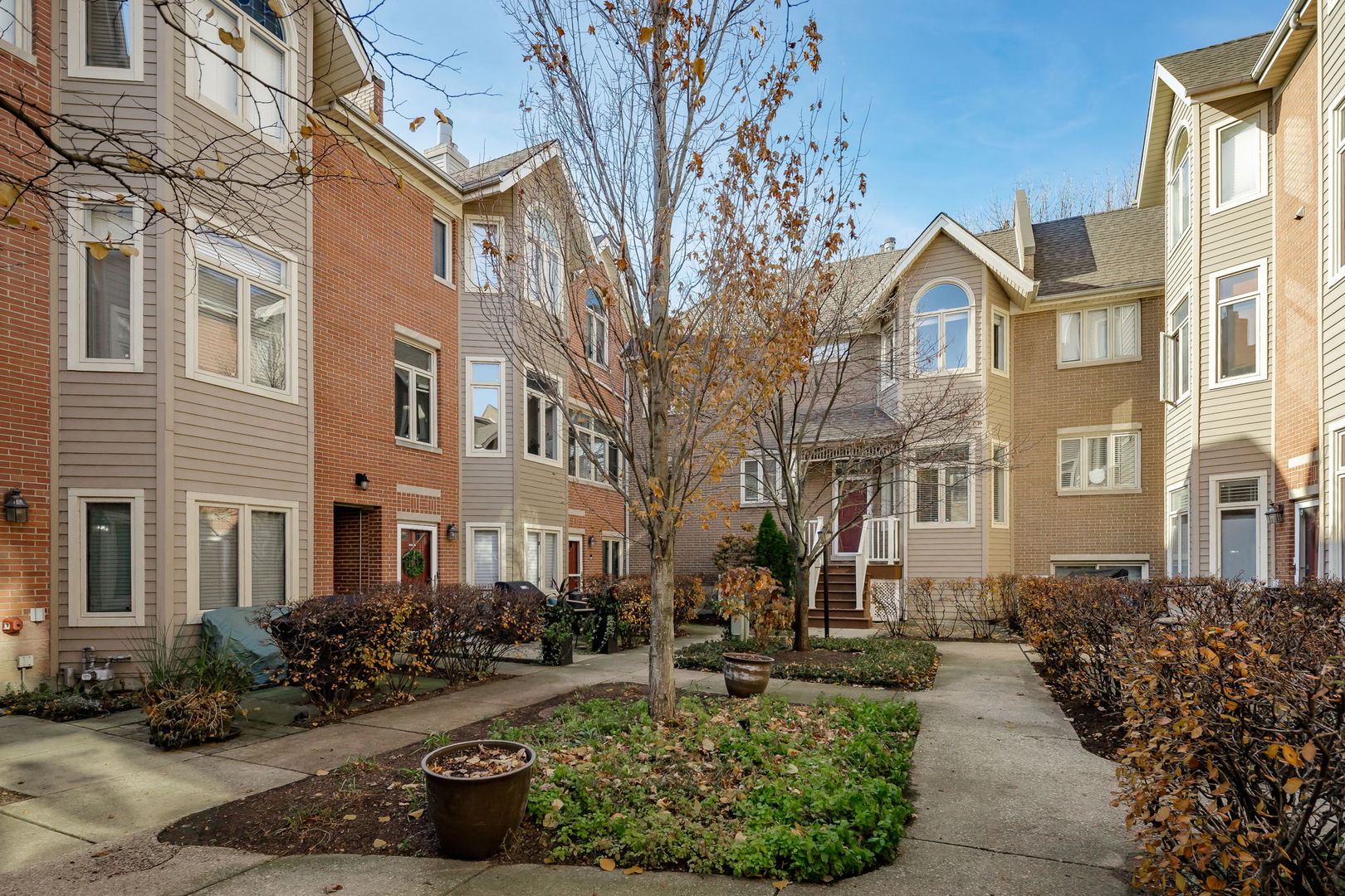 1251 West Fletcher Street, Unit J Chicago, IL 60657 - Photo 1 of 30 a front view of a residential apartment building with a yard