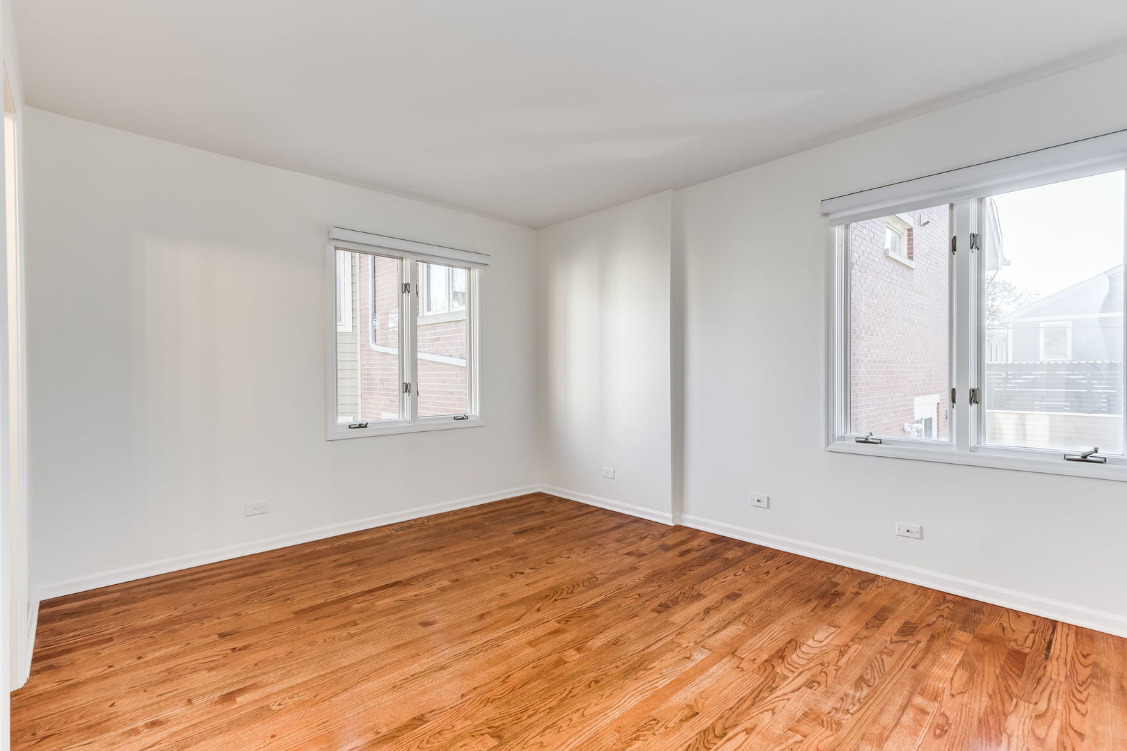 1251 West Fletcher Street, Unit J Chicago, IL 60657 - Photo 17 of 30 a view of empty room with wooden floor and fan