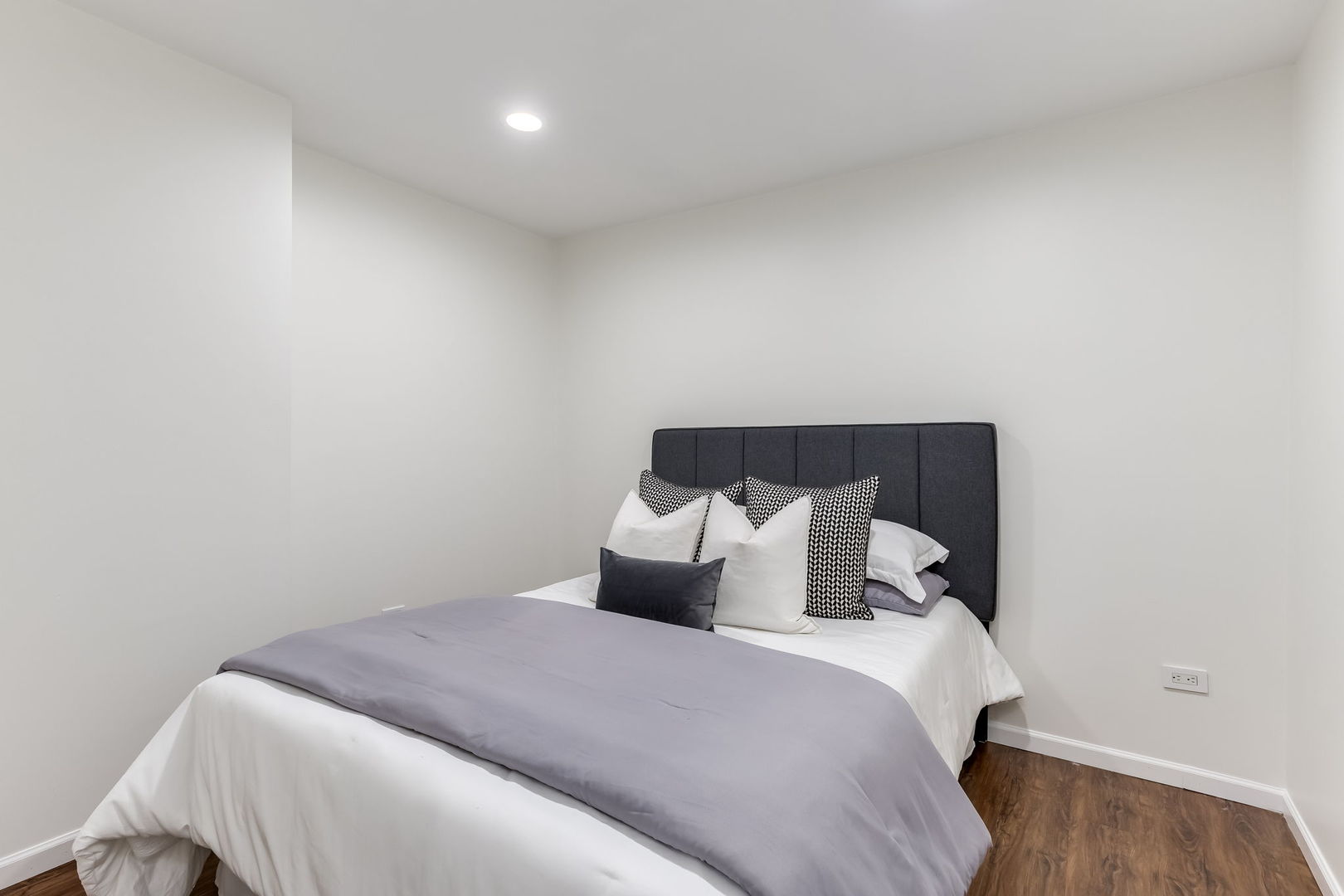 1251 West Fletcher Street, Unit J Chicago, IL 60657 - Photo 22 of 30 a bedroom with a bed and wooden floor