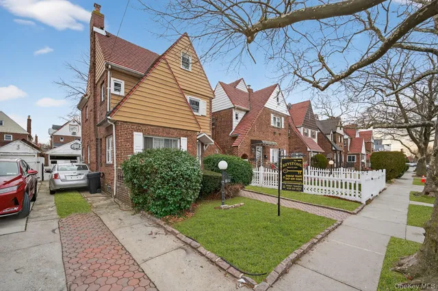 a front view of a house with a garden and plants