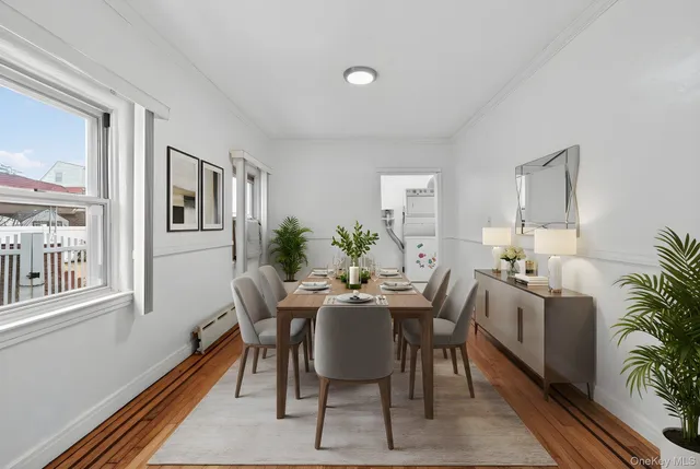 a view of a dining room with furniture window and wooden floor