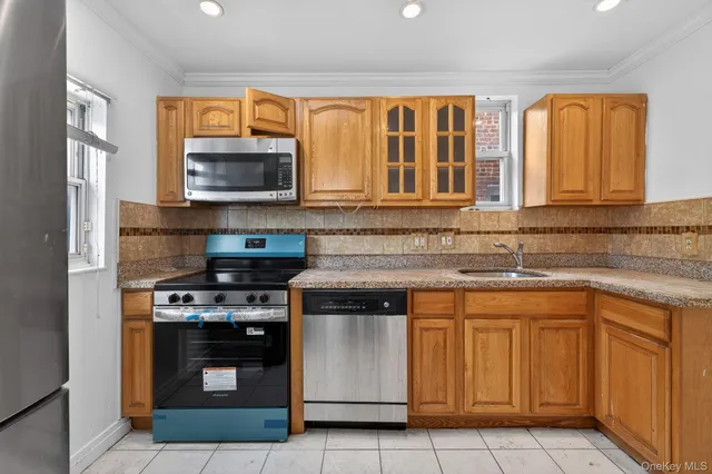 a kitchen with stainless steel appliances granite countertop a stove sink and microwave