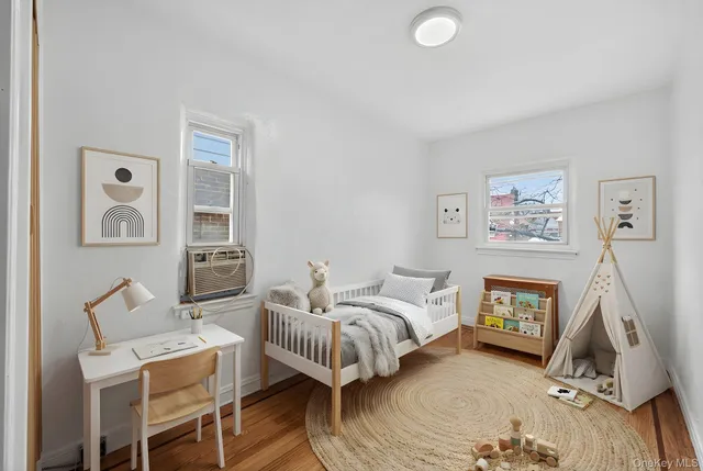 a bedroom with furniture and wooden floor