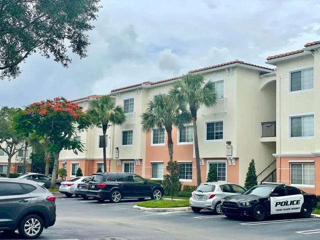 a car parked in front of a white house