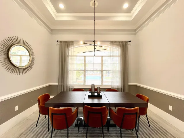 a dining room with furniture and window