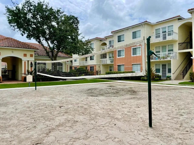 a front view of residential houses with yard and road