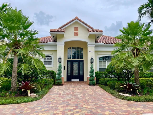 a front view of a house with garden