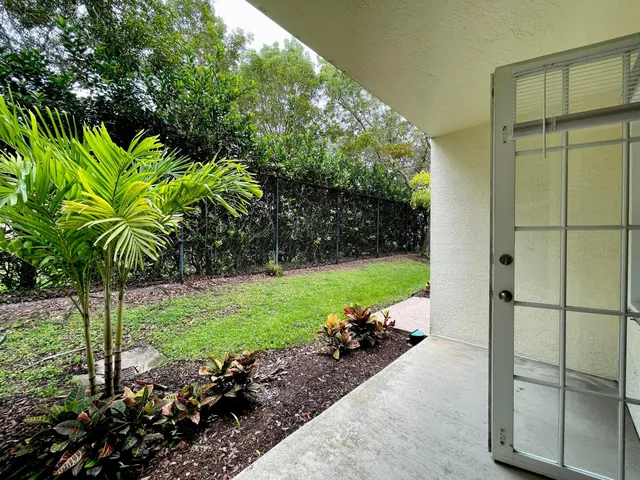 a garden with a tree in the background