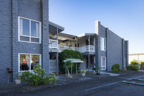 a front view of a house with plants