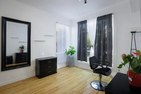 a living room with furniture potted plant and a window